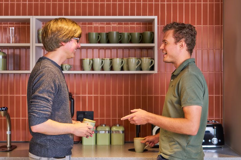 Staff members chatting in the kitchen.